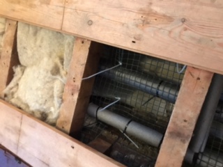 london installer insulation around the pipework under flooring